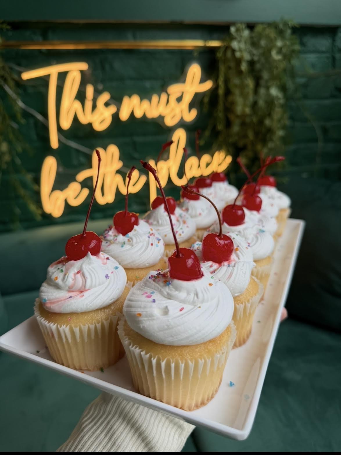 Pound cake cupcakes topped with cream and cherries